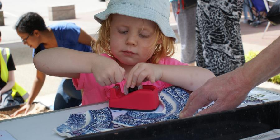 Page not found - Child at a community event fixing a broken plate